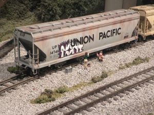 Figure 3 Unfinished Graffiti on a Hopper Car Across from the Modern City